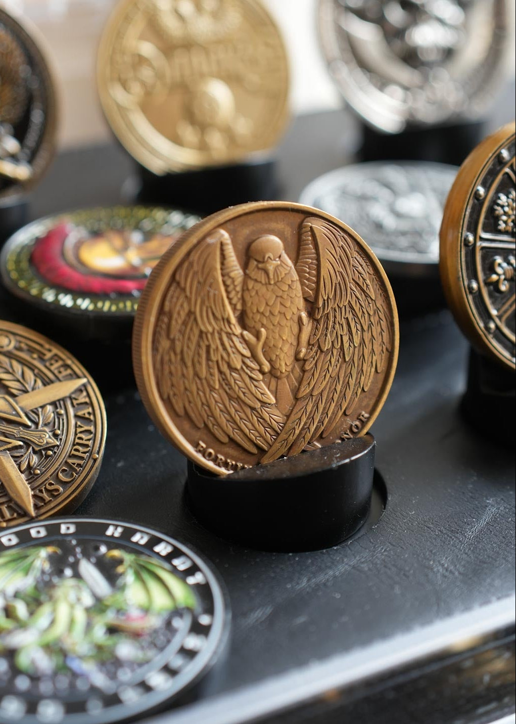 Collection of decorative coins with intricate designs on a dark surface