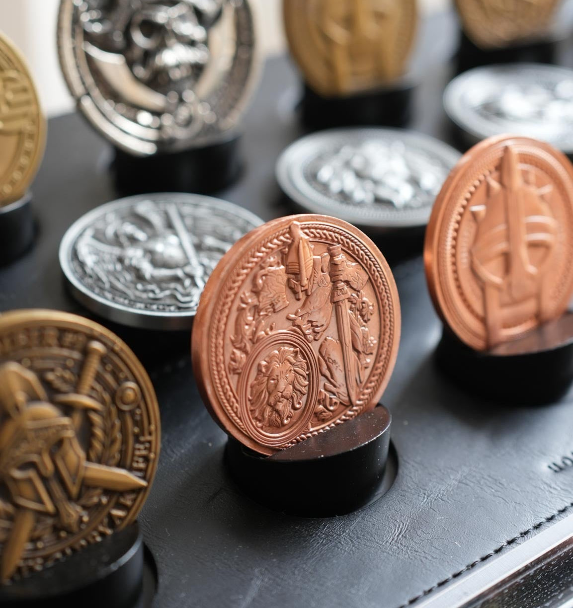 Collection of decorative coins on a black surface