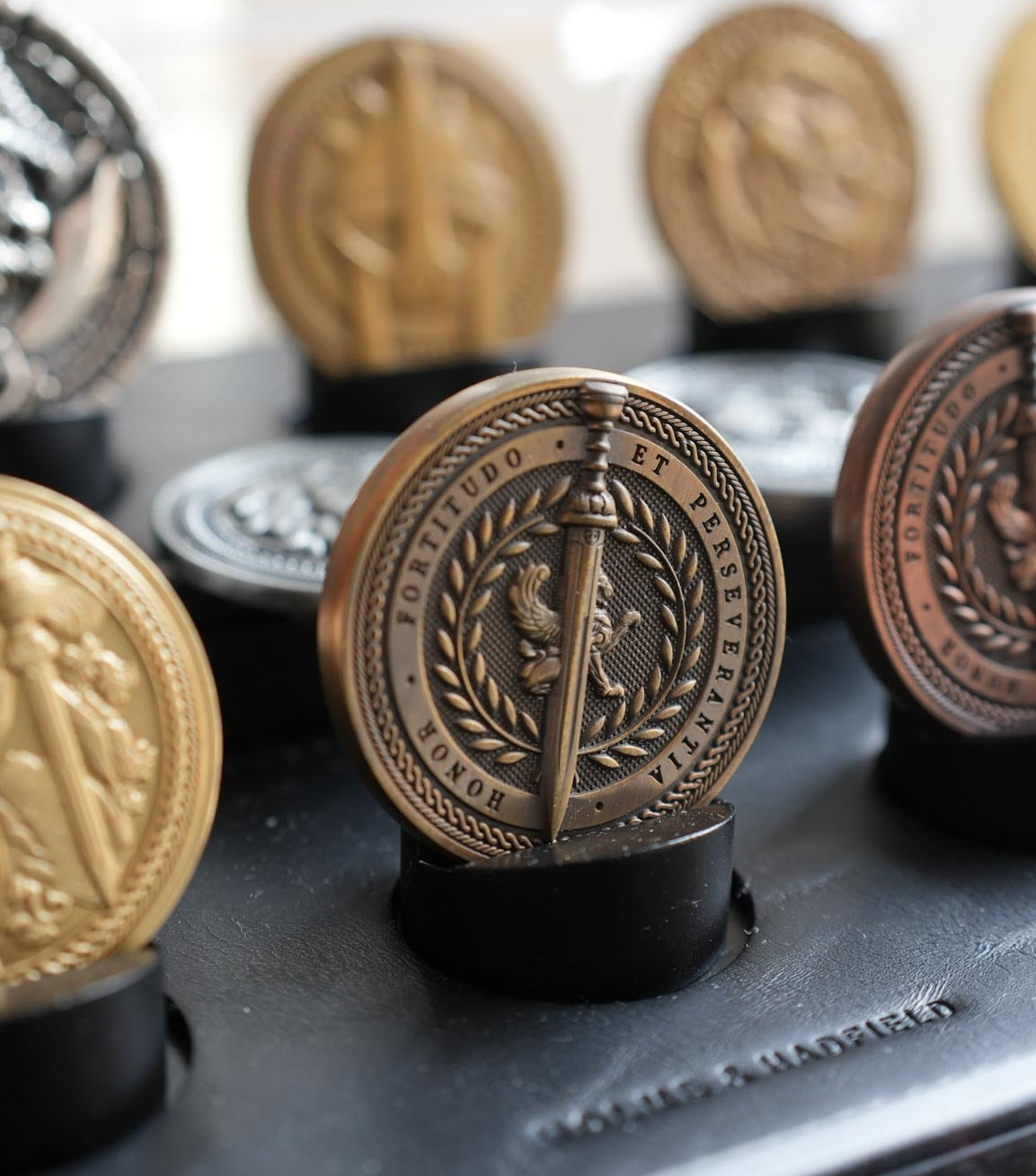 Collection of decorative buttons with intricate designs on a black surface.