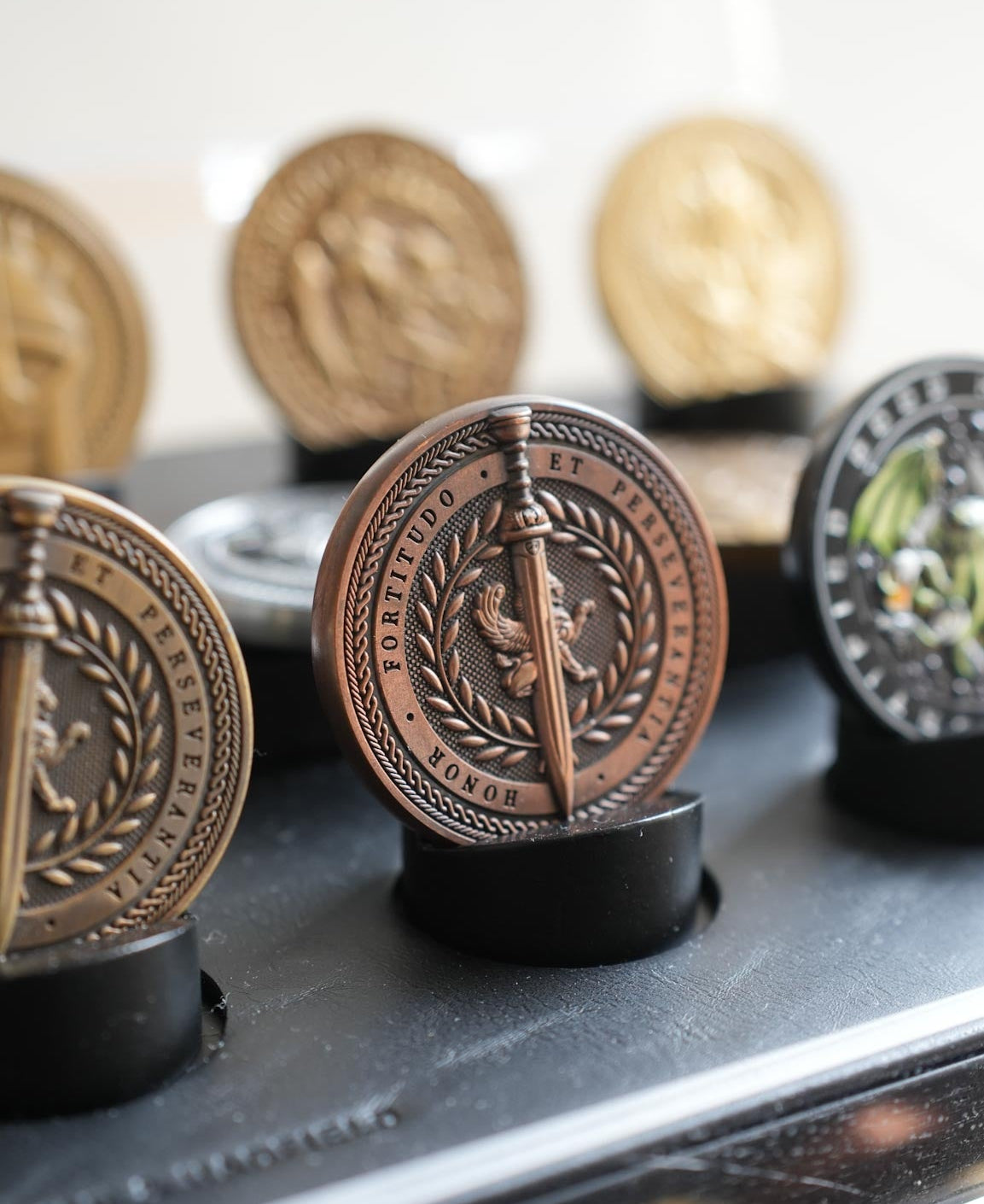 Collection of decorative coins on a stand with a blurred background