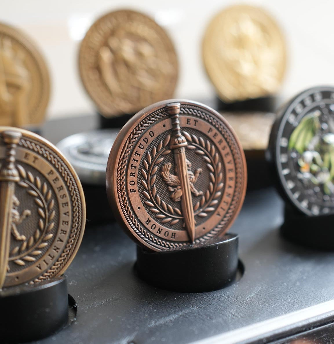 Collection of decorative coins on a stand with a blurred background