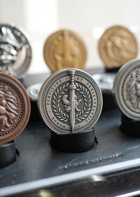 Collection of decorative metal medallions on a stand with blurred background