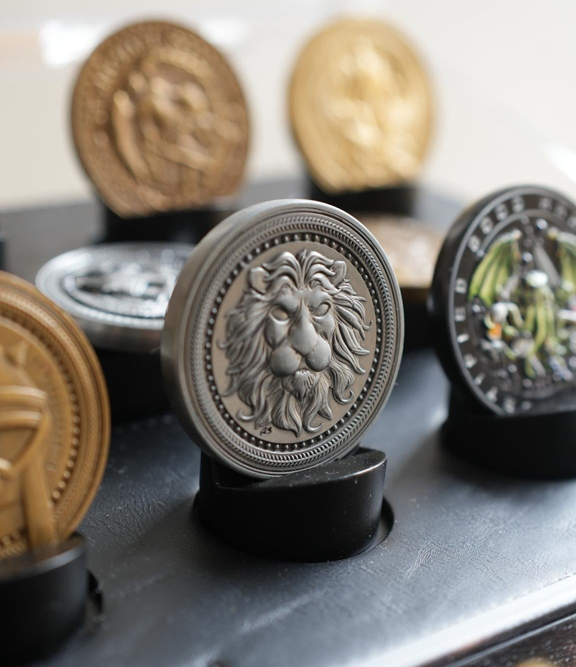 Decorative metal medallions with intricate designs on a reflective surface.