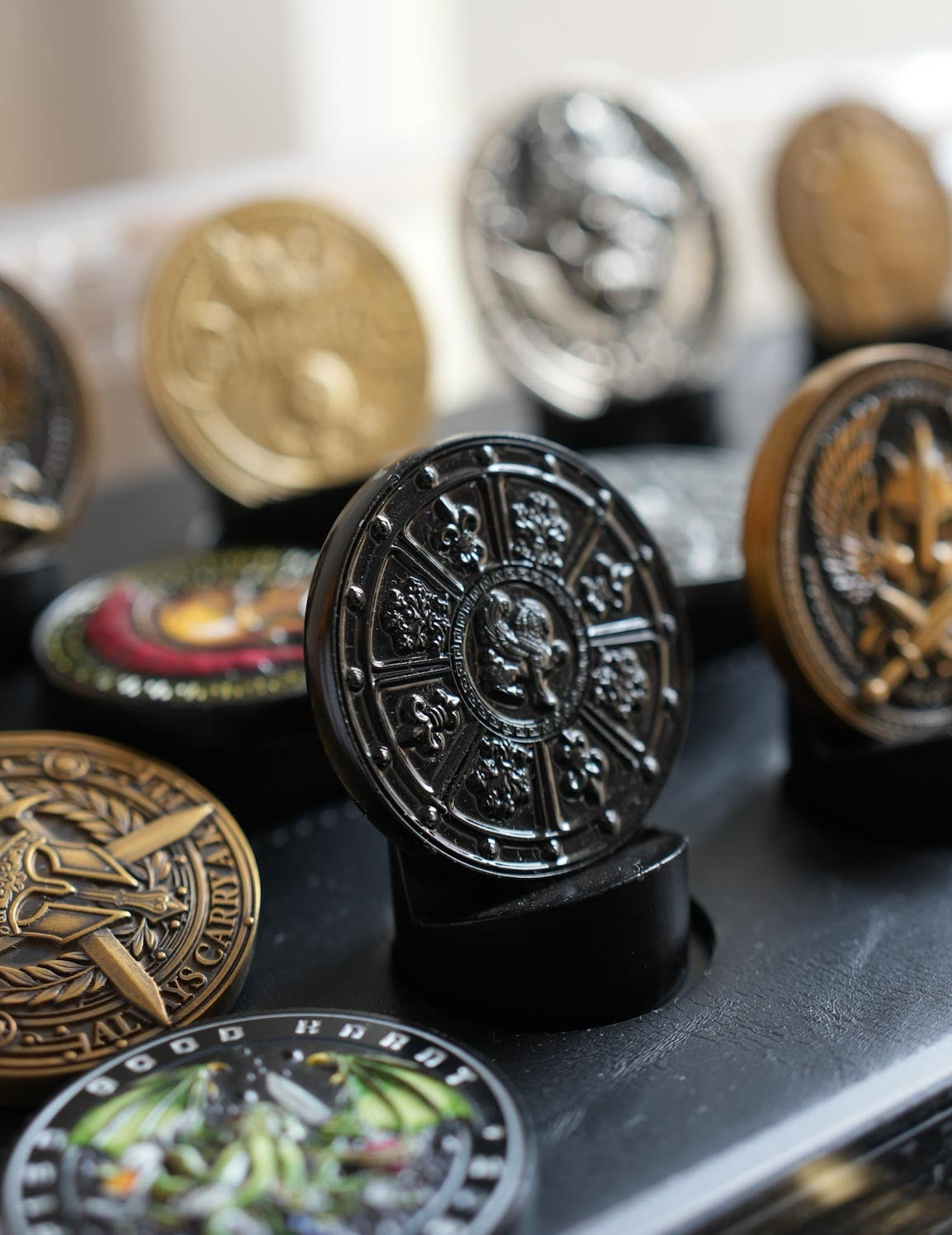 Collection of various coins on a reflective surface with a blurred background