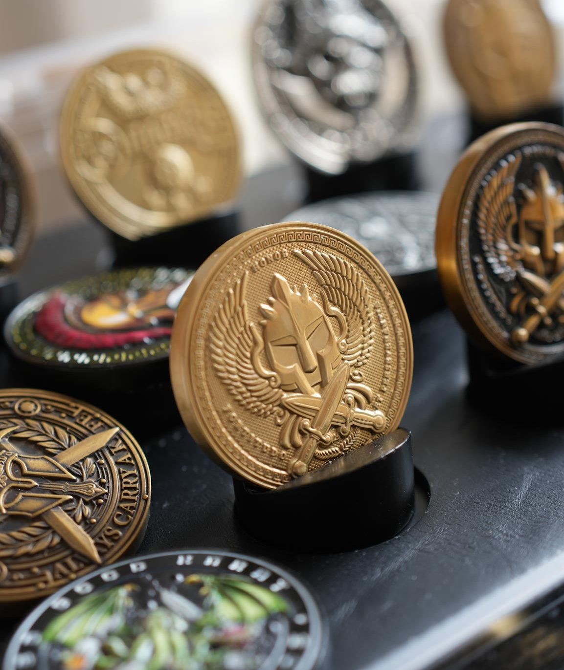 Collection of decorative coins on a black surface with a blurred background