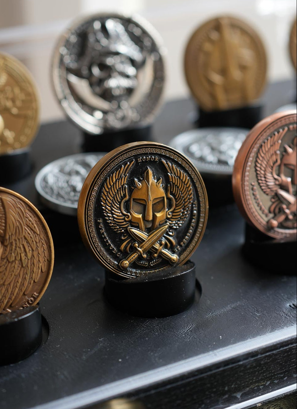 Collection of decorative coins on a black surface with a blurred background