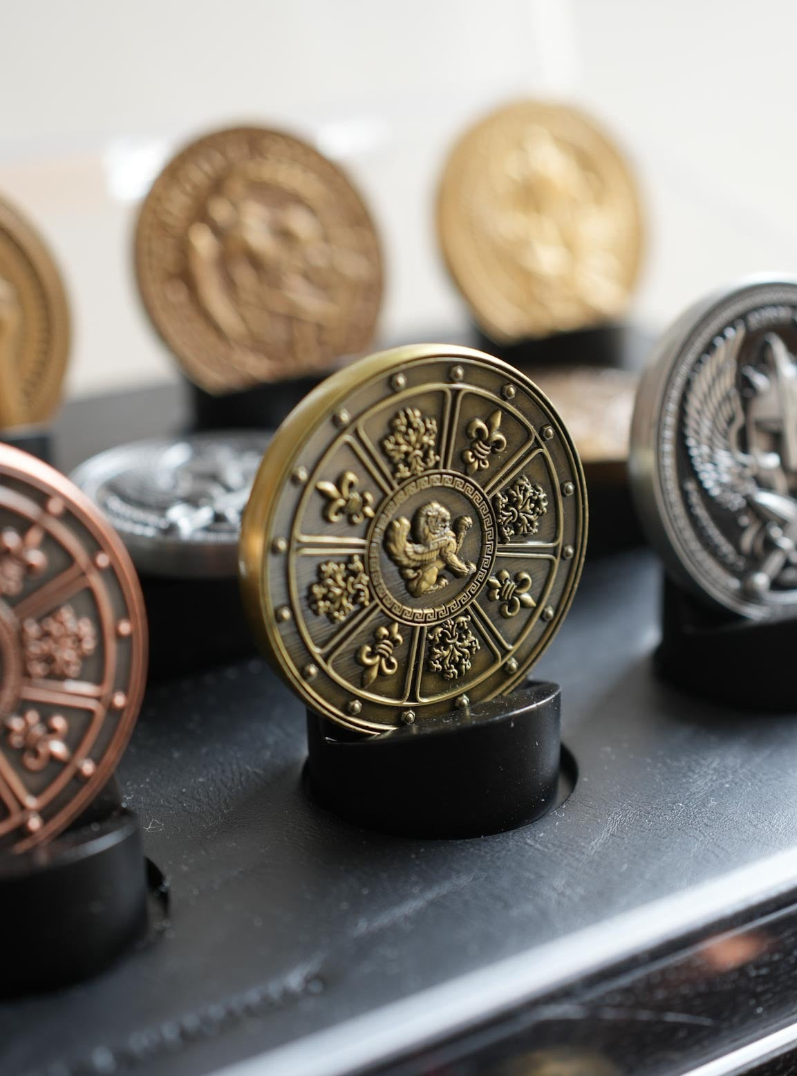Decorative coins on stands with a metallic sheen.