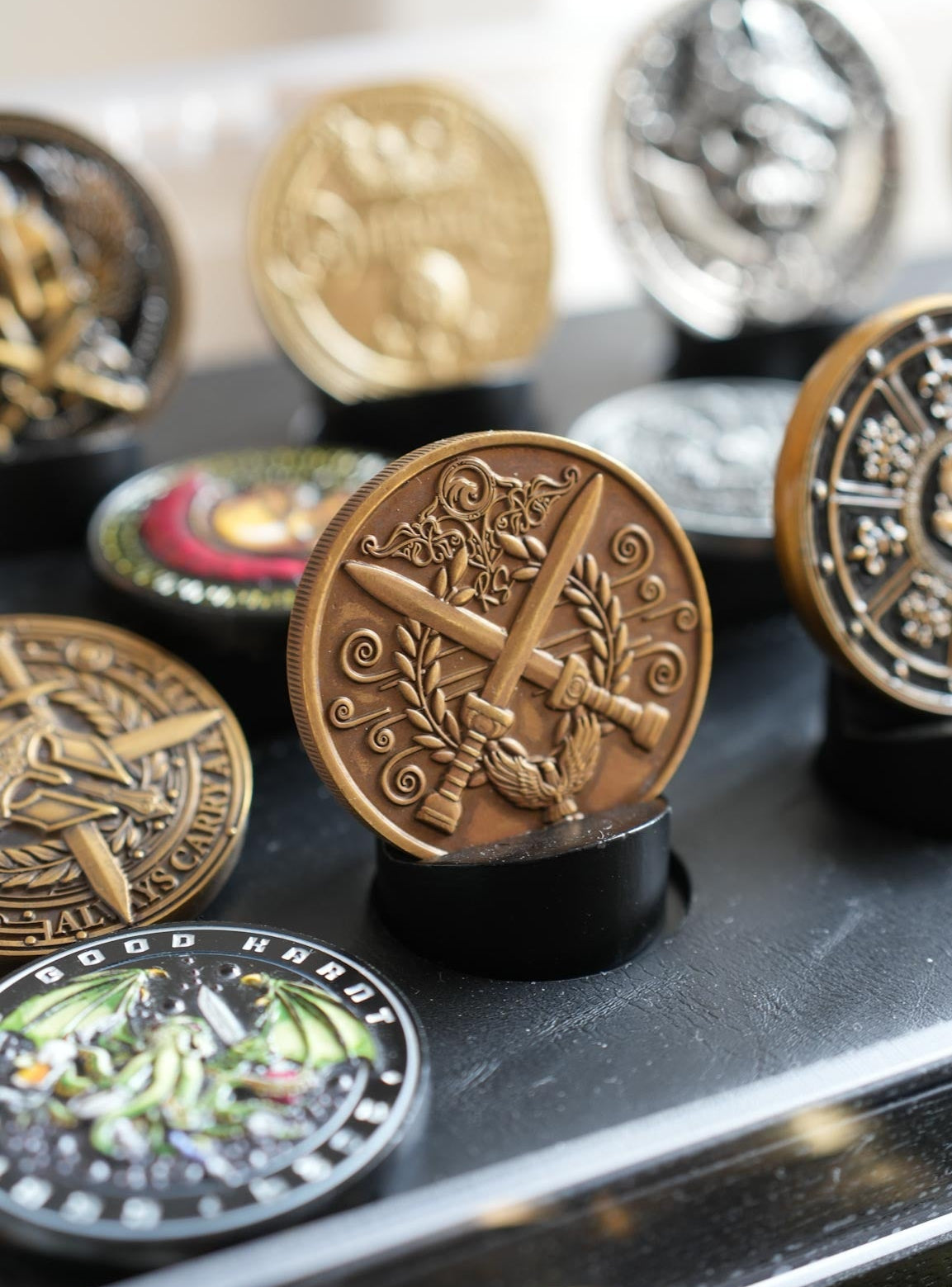 Collection of decorative coins on a black surface with a blurred background
