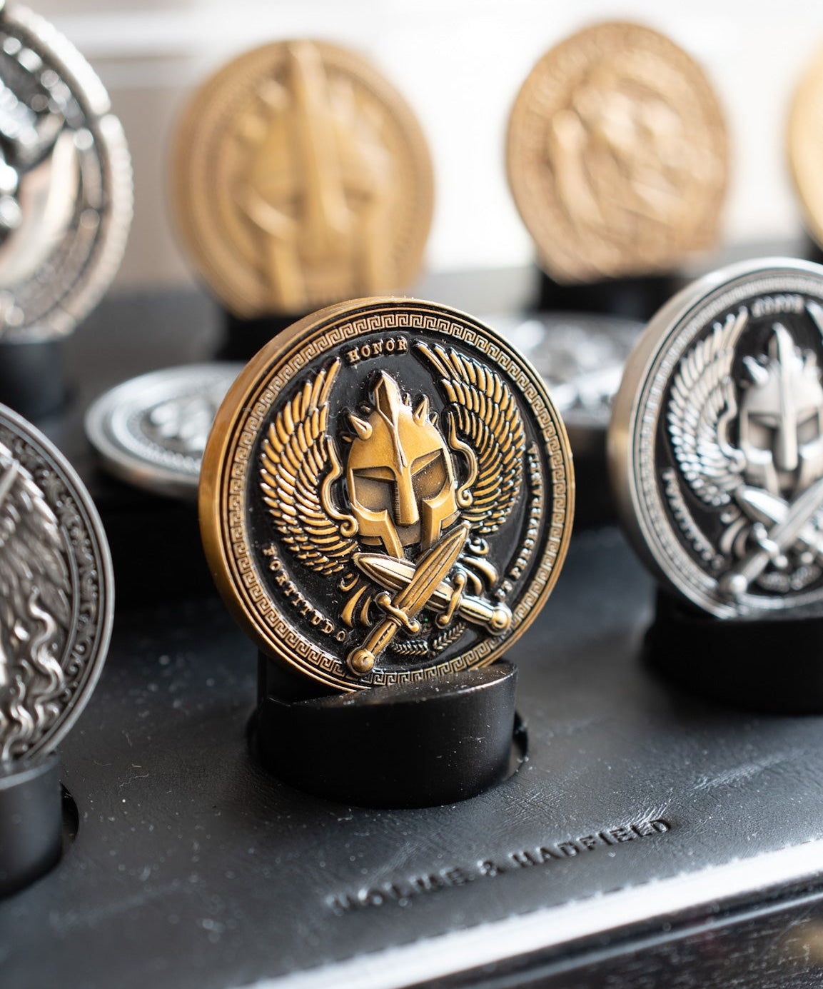 Decorative coins with intricate designs on a black surface
